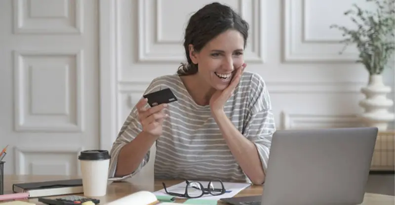 Happy businesswoman uses payments processing software - Artsyl
